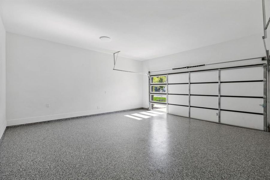 Beautiful epoxied garage floor with windows for natural sunlight.