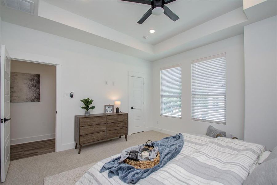 Primary bedroom with lots of natural light Model home photos - FINISHES AND LAYOUT MAY VARY! Ceiling fans are NOT INCLUDED!
