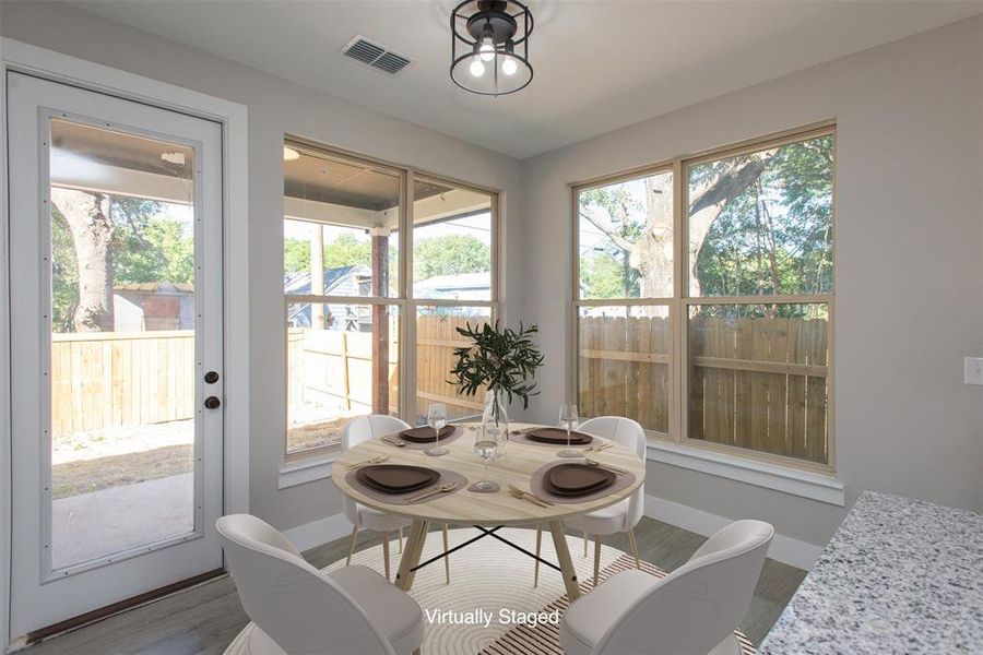 Dining room featuring a healthy amount of sunlight and light hardwood / wood-style flooring