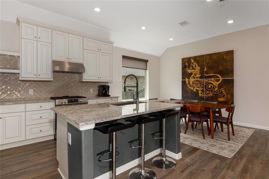 Kitchen has undercabinet lighting and a large island