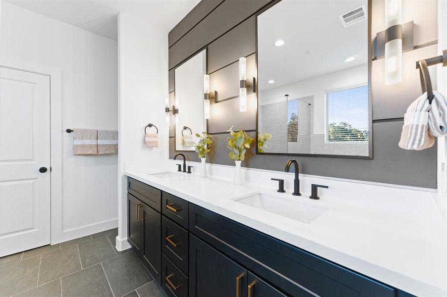 Luxurious primary bath with double vanities & upgraded cabinets.