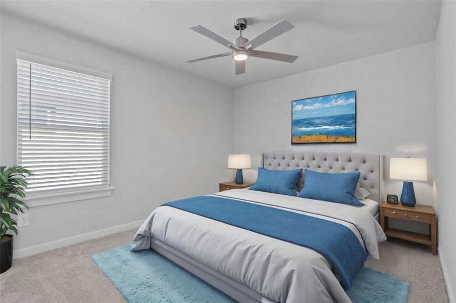 Secondary bedroom features plush carpet, neutral paint, ceiling fan, and a large window with privacy blinds.