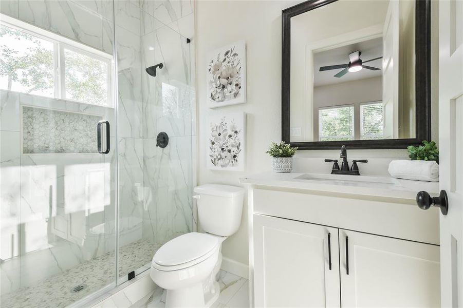 Third bathroom adjoins 4th bedroom has step in frameless shower and undercount sink with Quartz countertop.