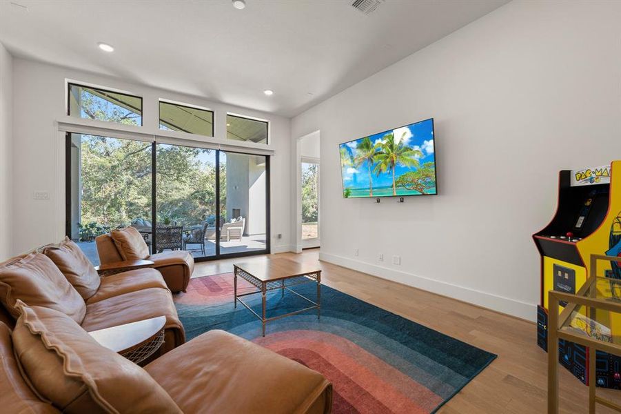 Downstairs media room with a slider wall to the backyard.