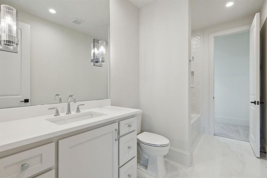 Full bathroom with shower / tub combination, vanity, tile patterned flooring, and toilet