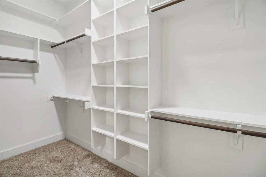 Walk in closet with light carpet