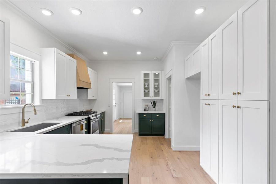 Floor to ceiling cabinets with pull out drawers can be used for storing cooking essentials and all of your pantry necessessities.