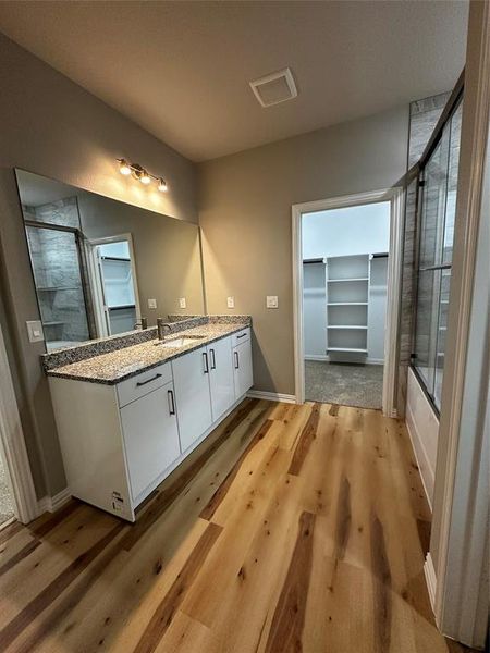 Bathroom with vanity and hardwood / wood-style flooring