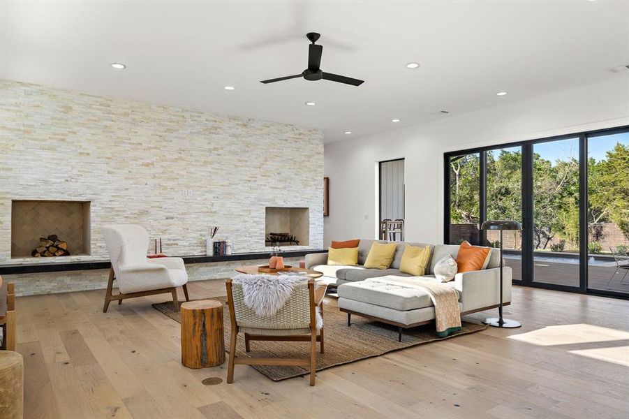 Large living room with sliders opening to pool and deck. Wood burning fire place with gas starter and built in fire wood storage.