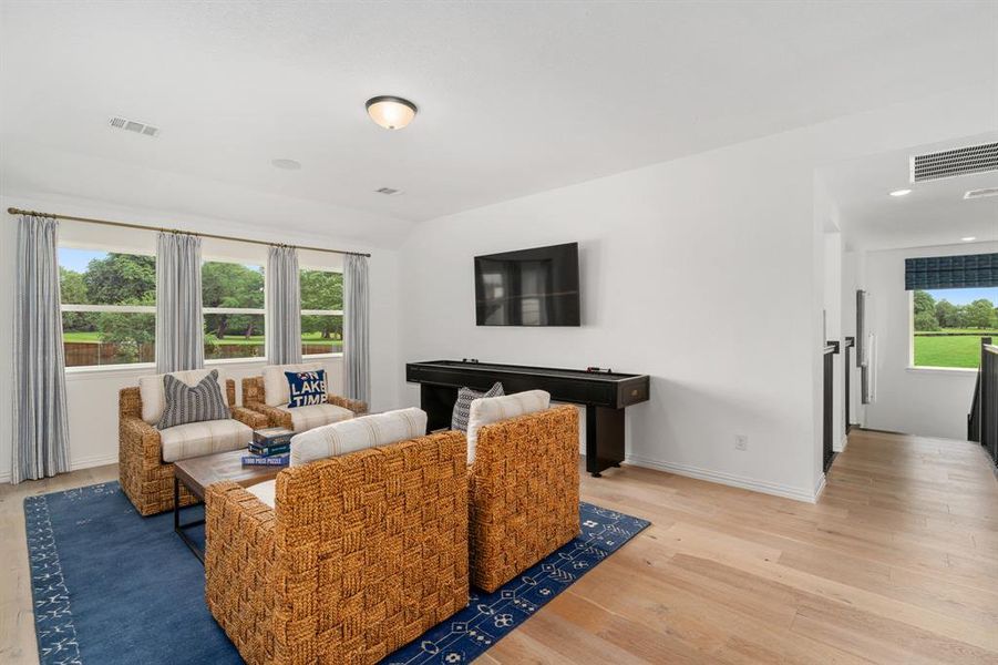 Living room with light hardwood / wood-style flooring