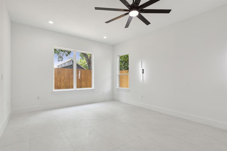 Unfurnished room featuring ceiling fan and light tile flooring