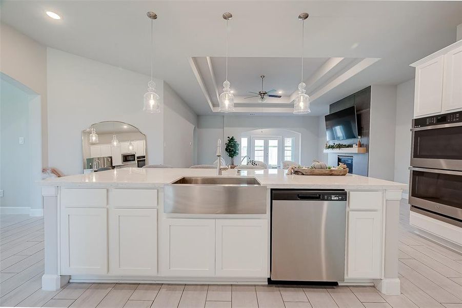 The kitchen features white cabinets,creating a clean and timelessaesthetic.