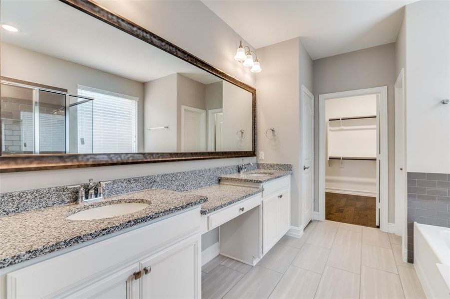 Bathroom with plus walk in shower, hardwood / wood-style flooring, and vanity