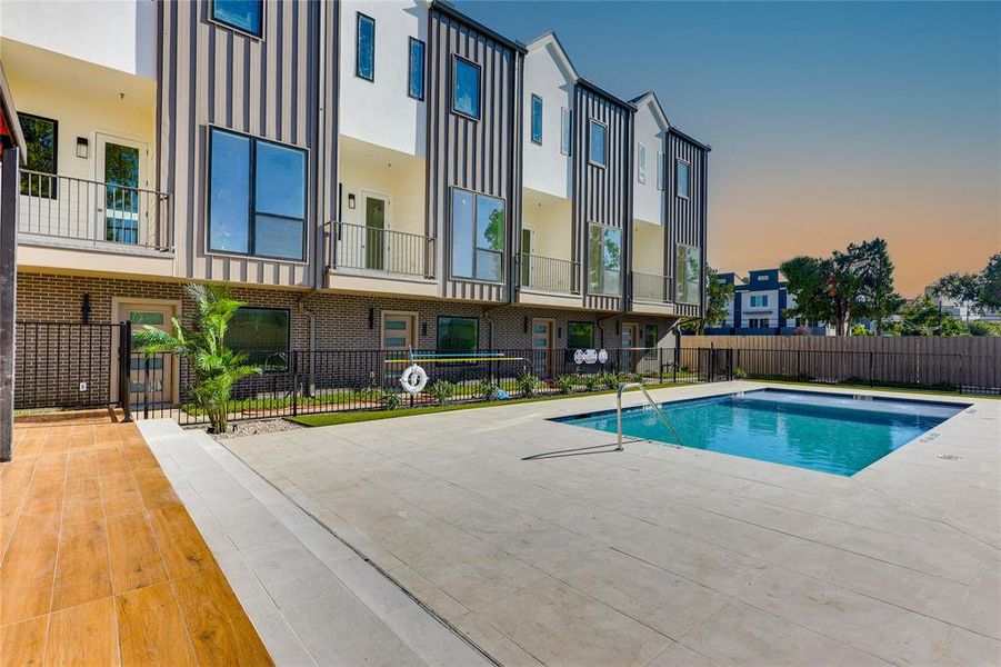 Pool at dusk featuring a patio area