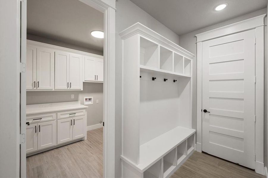 Mudroom with light hardwood / wood-style floors