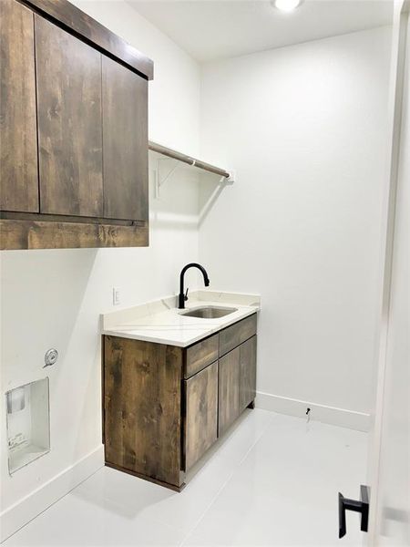 Clothes washing area with sink