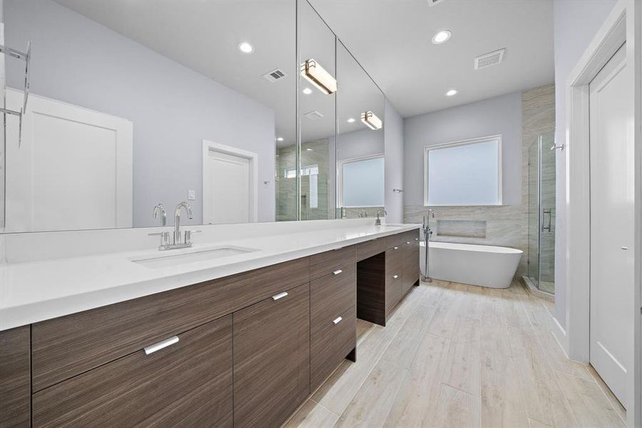 Spacious primary bathroom with high-end fixtures and finishes.