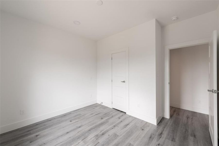 *Representative Photo. This is a bright, clean room with neutral walls and modern gray wood flooring.