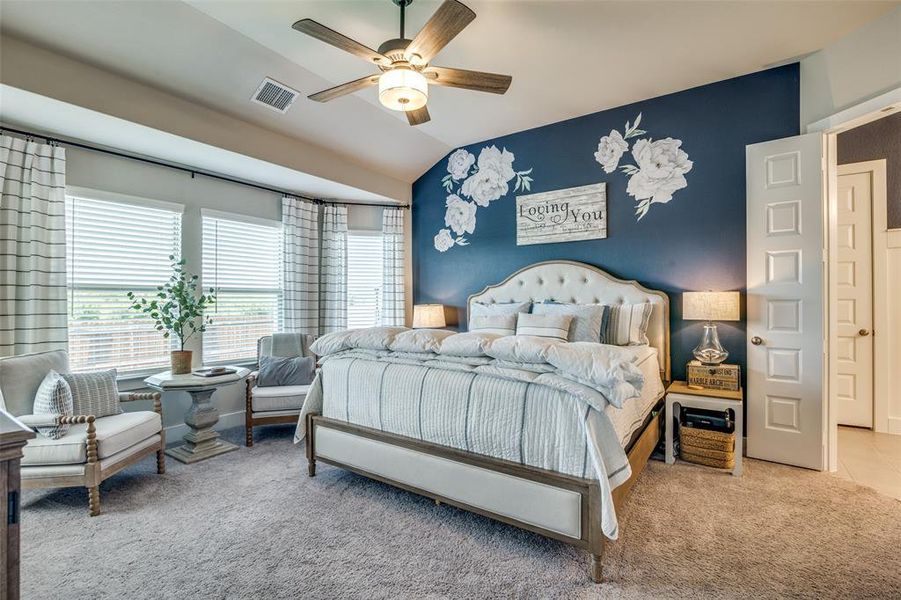 Bedroom with ceiling fan, lofted ceiling, and carpet flooring