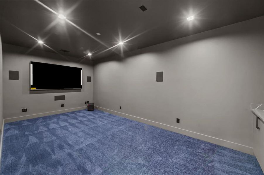 Media room with carpet, TV and speakers installed