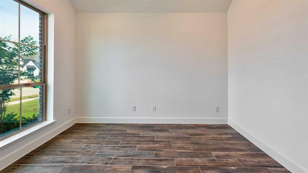 Spare room featuring dark hardwood / wood-style flooring