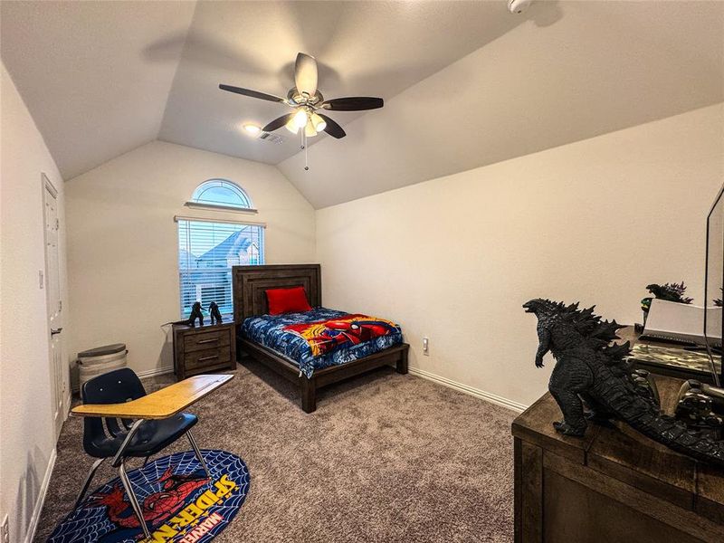 Bedroom with lofted ceiling, carpet flooring, and ceiling fan