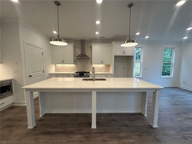 Massive island with quartz countertops perfect for gathering and entertaining. Photo not actual home, but previously built Stockton plan.