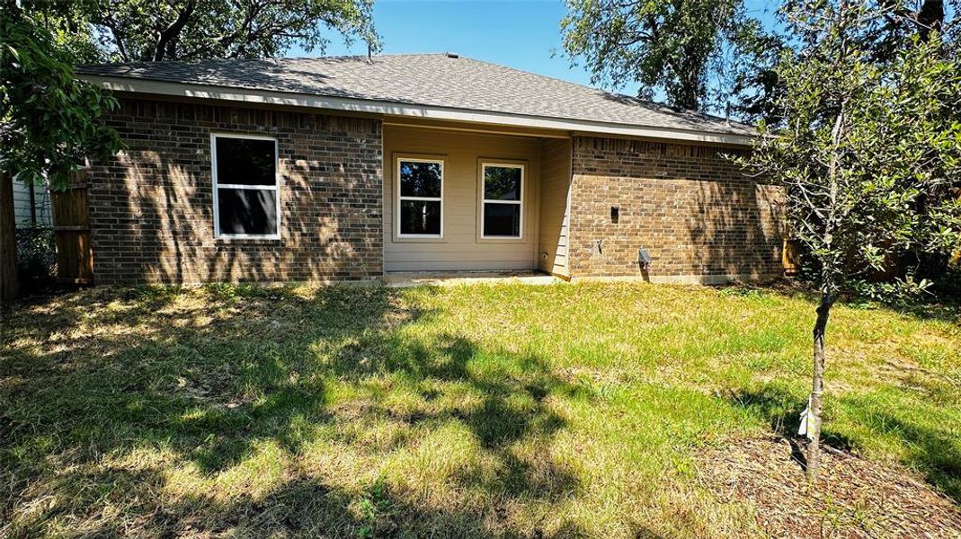 Rear view of property featuring a yard