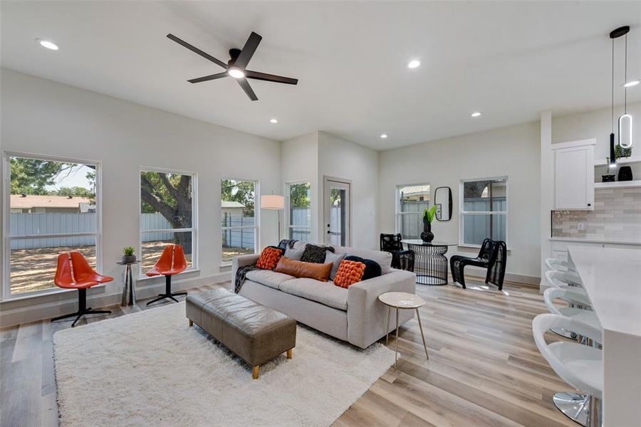 Living room featuring a healthy amount of sunlight, ceiling fan, and LVL flooring