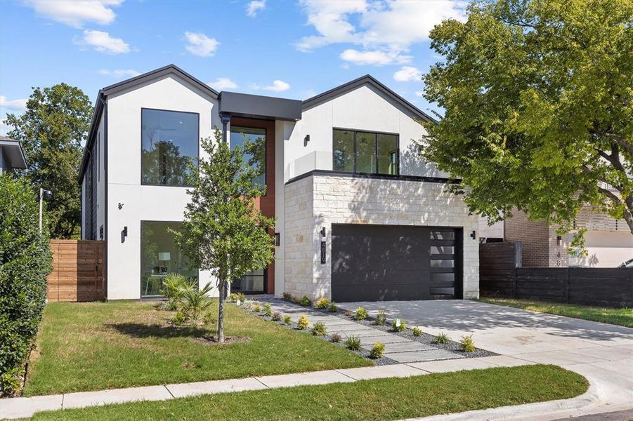 Modern home with a garage and a front lawn