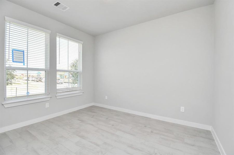 Quietly nestled in front of the home is the sophisticated home office. Featuring elegant tile, custom paint and large window. Sample photo of completed home with similar floor plan. Actual colors and selections may vary.