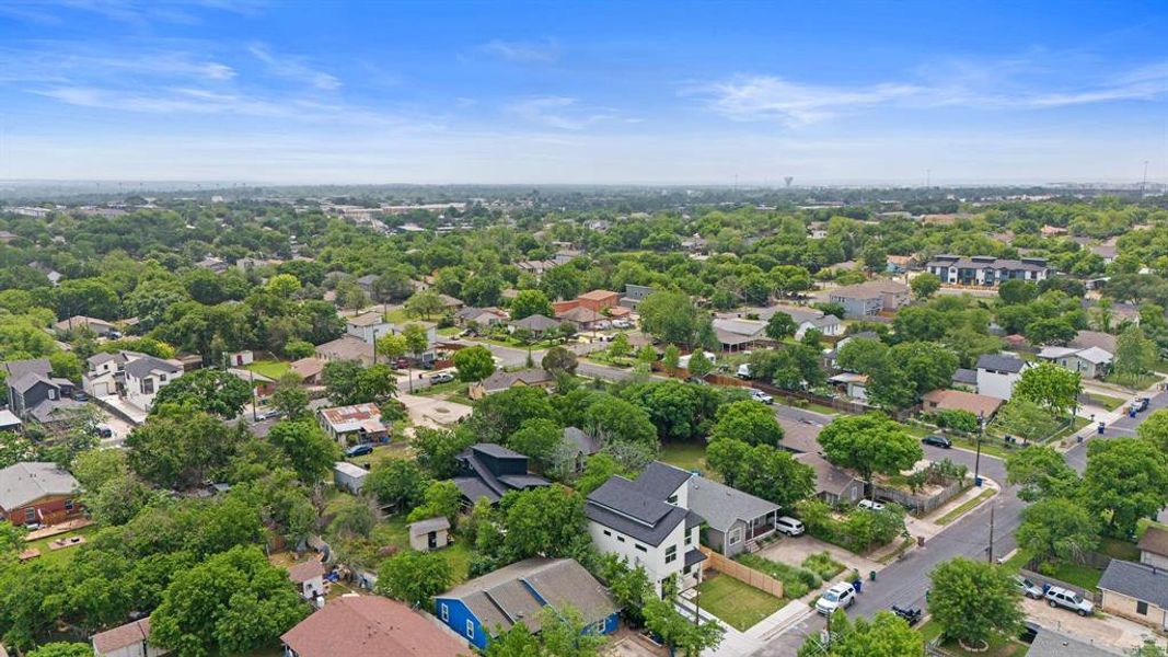 Aerial view showing the home tucked into the trees.