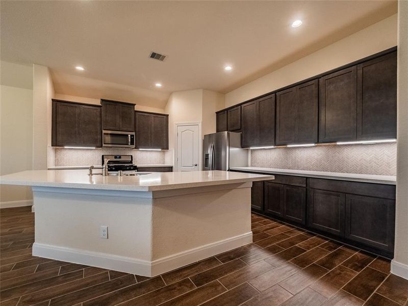 the kitchen has lots of cabinets, over sized island with your sink plenty of room for at least 6 bar stools