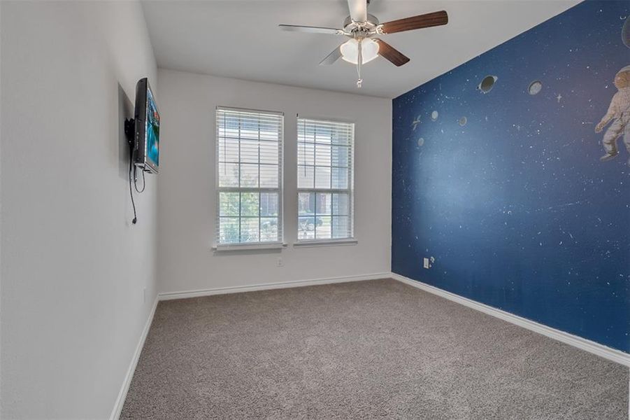 Spare room with carpet and ceiling fan