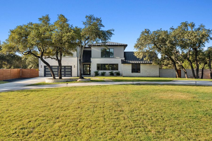 Circular driveway and two-car garage with ample parking for entertaining.