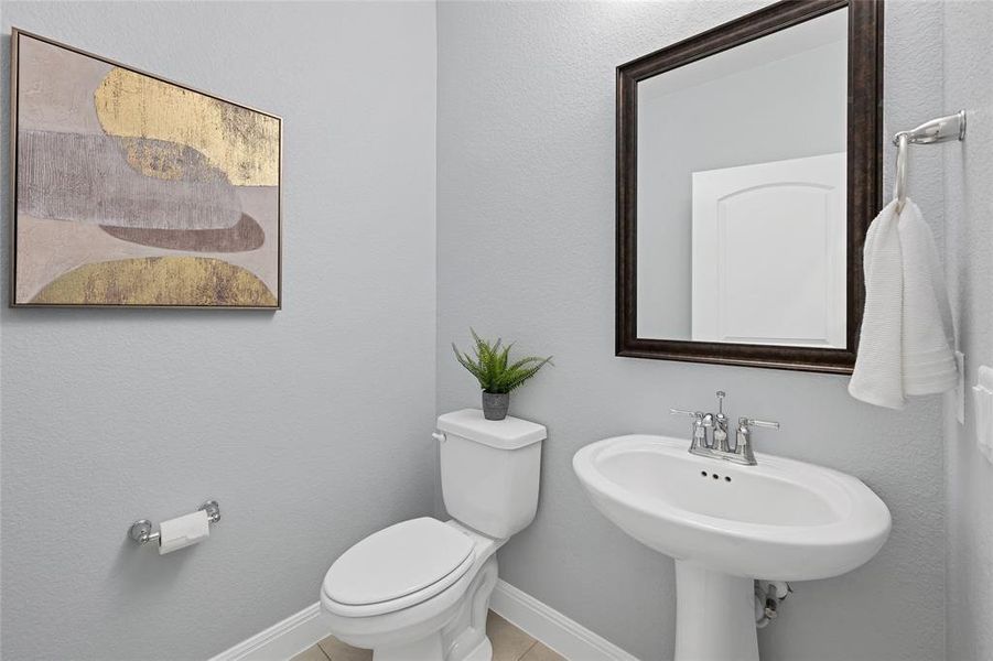 Downstairs powder bath located between office and stairwell.