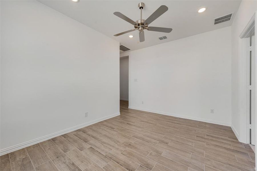 Empty room featuring light hardwood / wood-style floors and ceiling fan