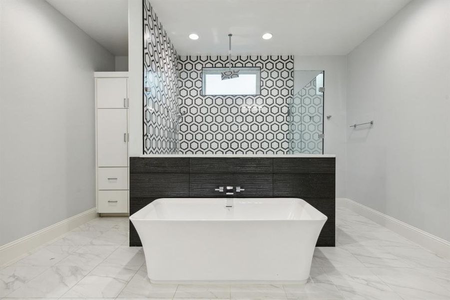 Large free-standing tub with black accent tile really sets the stage...and the designer tile in the shower adds that WOW factor!