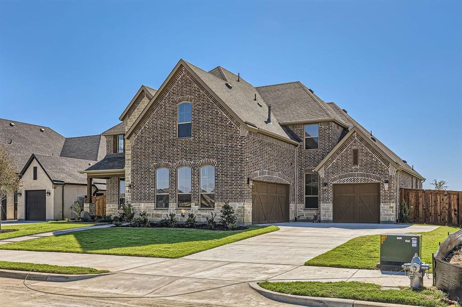 View of front of house featuring a front yard and a garage