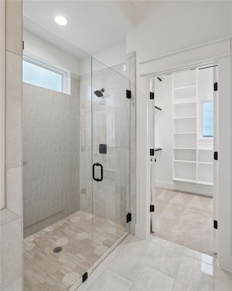 Bathroom with tile patterned flooring and walk in shower