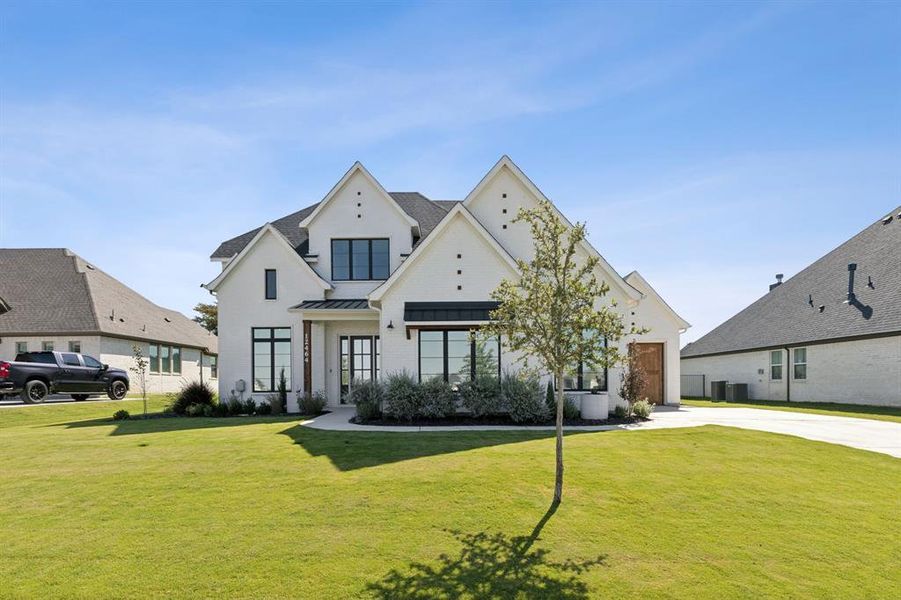 View of front of property with a front yard and central AC unit