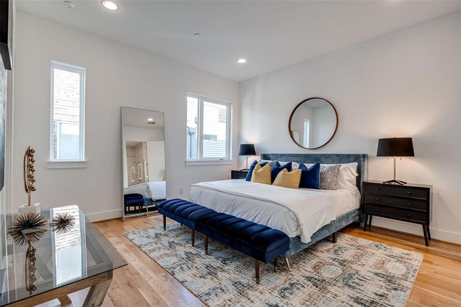 Bedroom with wood-type flooring and multiple windows