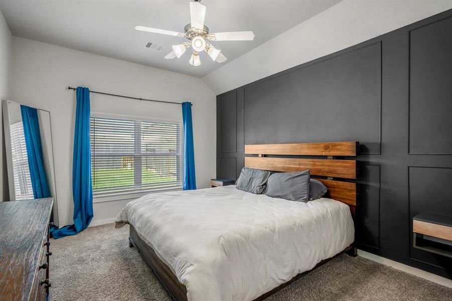 The primary bedroom welcomes you with bright natural light and a custom accent wall! It sits at the back of the home offering additional privacy and easily fits a king size bed! *This photo has been virtually staged