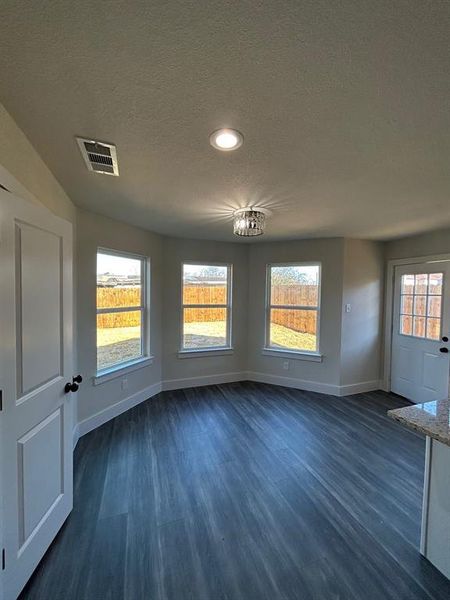 Dining area featuring wood-type flooring and several windows offering natural lighting