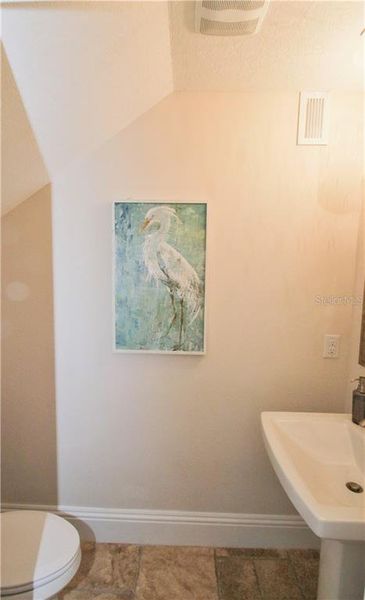 1st level half bath  Pictures are of builder’s model, actual townhome may differ in elevation and options.