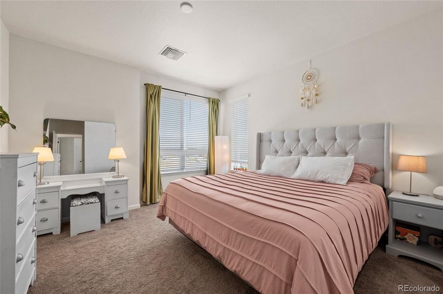 The primary bedroom has lots of light and a corner northeast view.