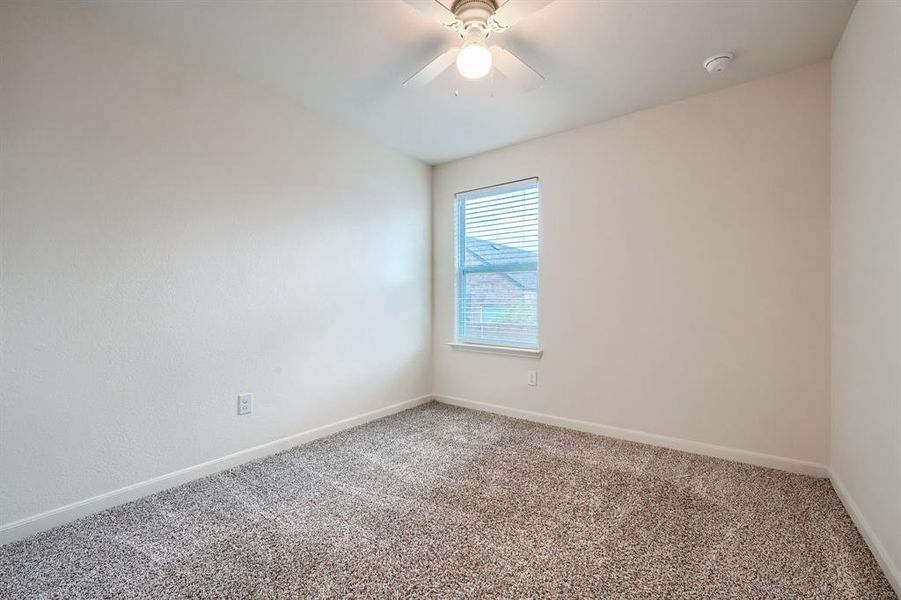 Unfurnished room featuring carpet and ceiling fan