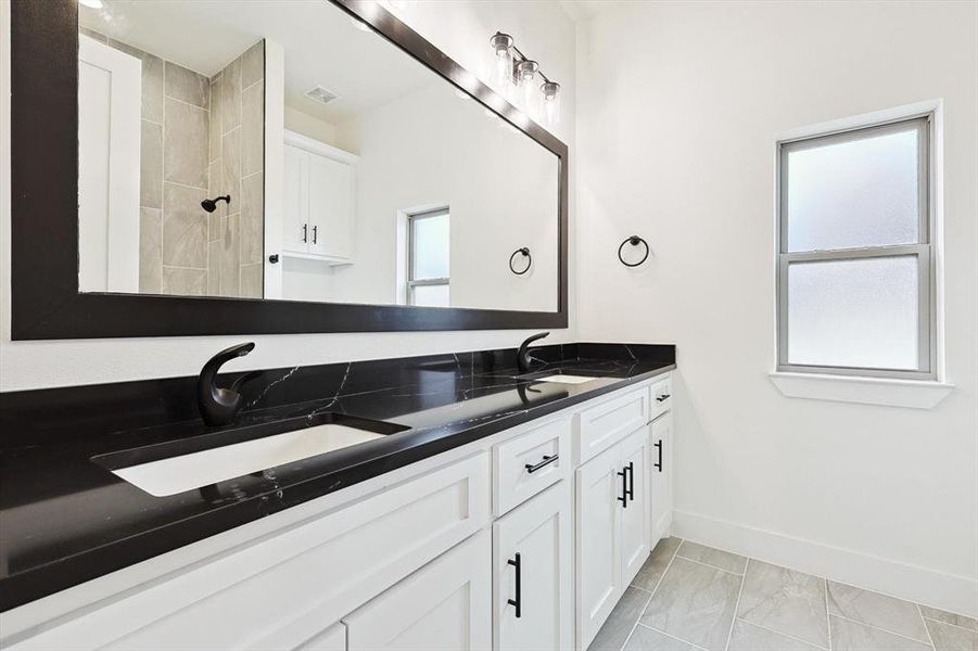 Bathroom featuring a shower and vanity