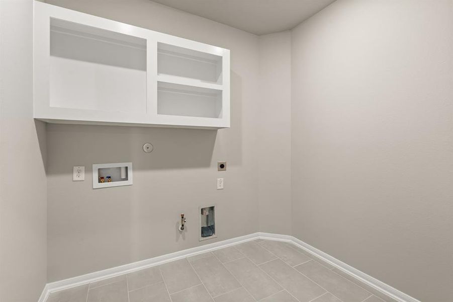 The laundry room layout is carefully planned for optimal workflow with designated areas for washing, drying, and storing.