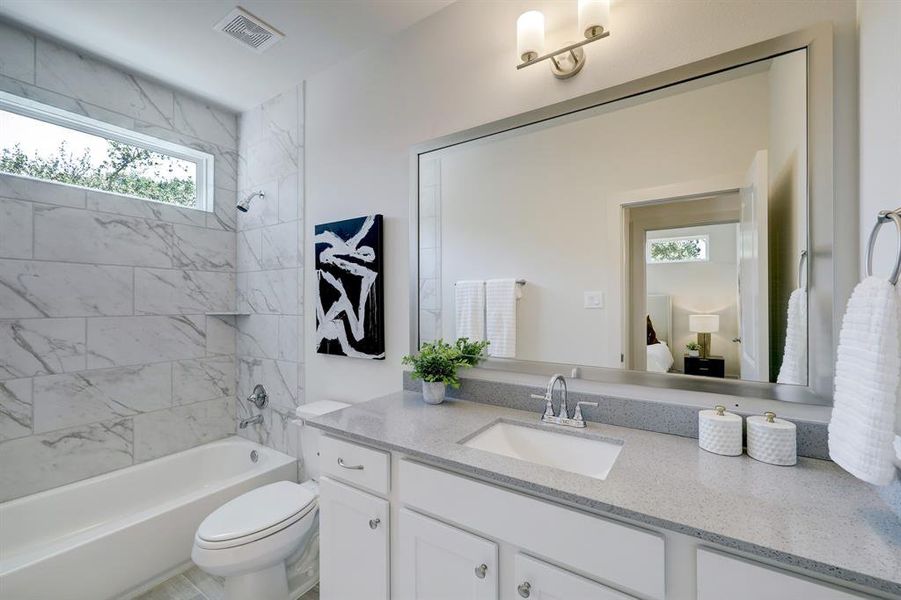 The home also features a well-appointed bathroom, designed with modern fixtures and finishes.